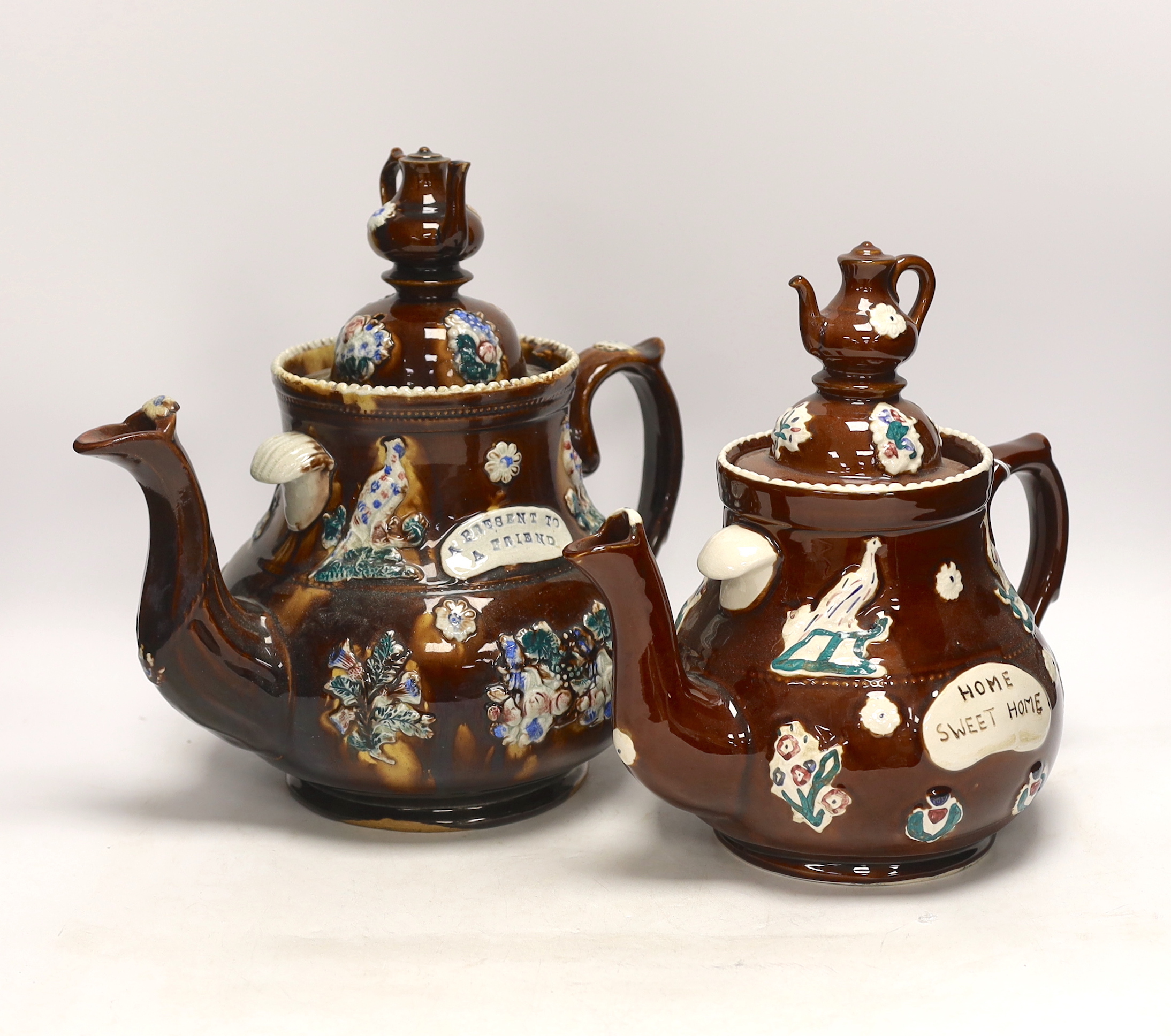 A late 19th century Measham barge ware teapot and cover, 31.5cm high, together with a reproduction teapot in the same style